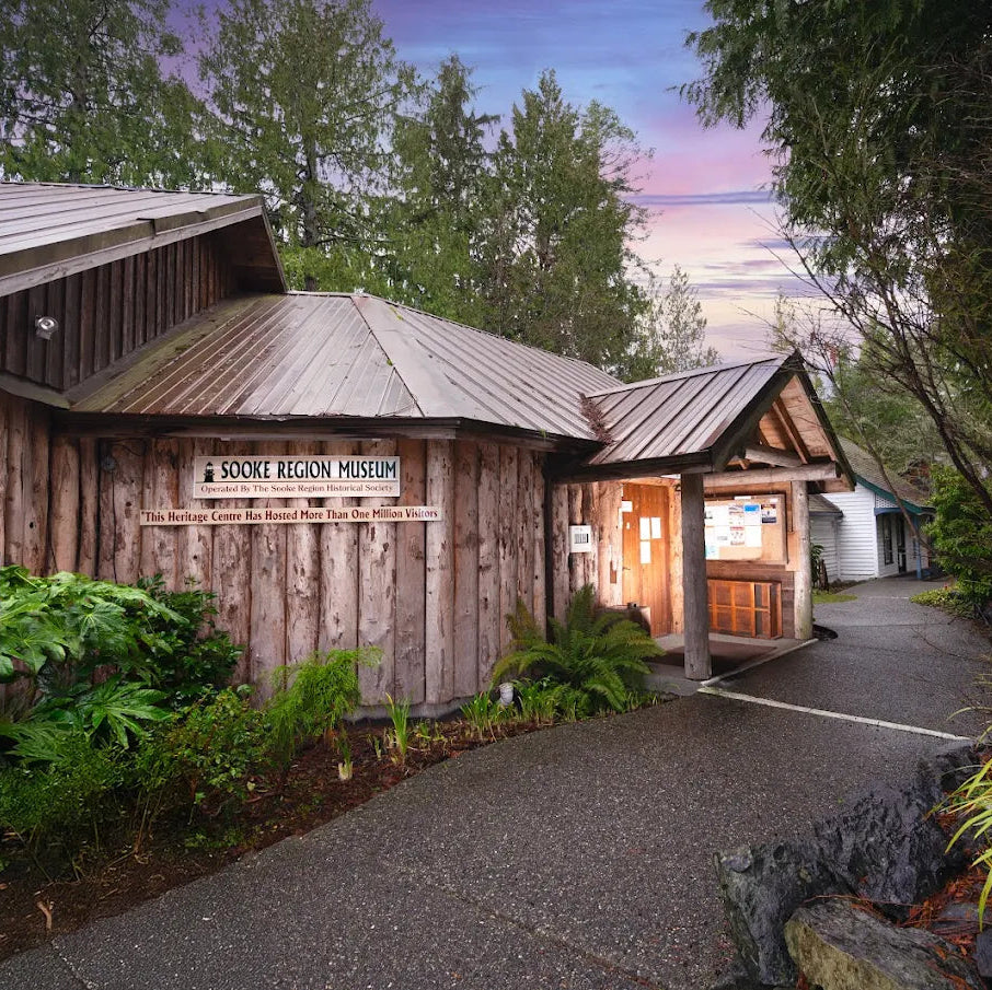 Wooden building with 'Visitor Centre' sign and 'Boone Region Museum' sign, surrounded by trees and plants.